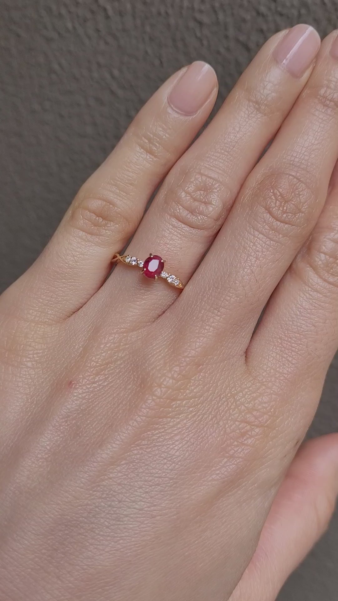 video of a Natural Ruby & Diamond Twisted Band Ring in 18K Yellow Gold worn on a hand in neutral background