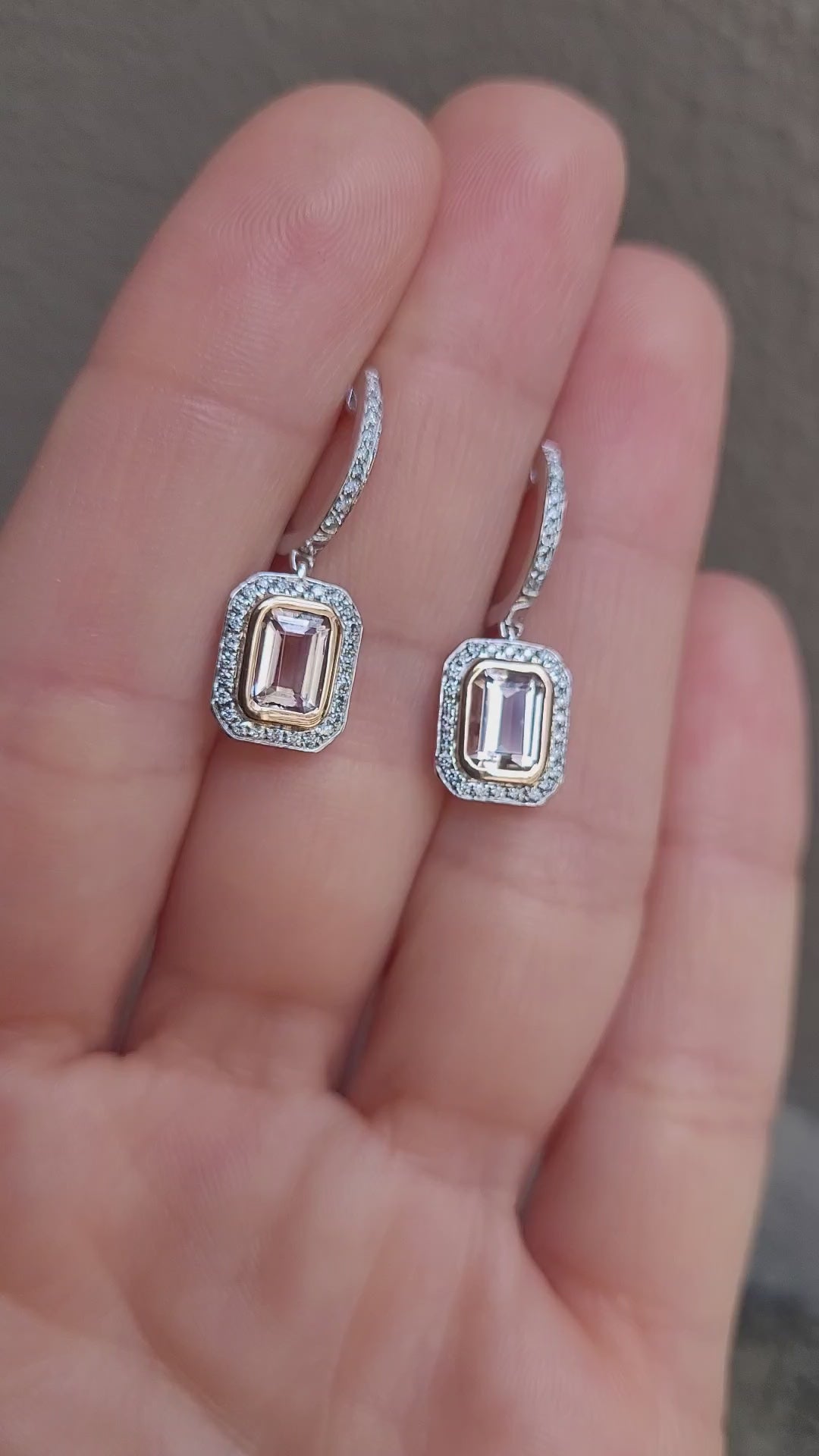 video on hand of morganite and diamonds gold earrings in light gray background