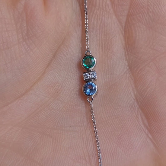 video of Colombian Emerald, Diamond and Blue Sapphire Bracelet in Platinum 950 held in a hand