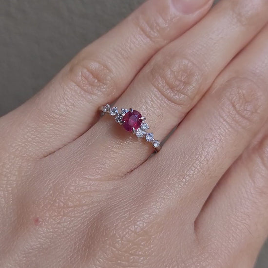 video on of hand wearing a natural ruby and diamond ring in platinum 950 in neutral background