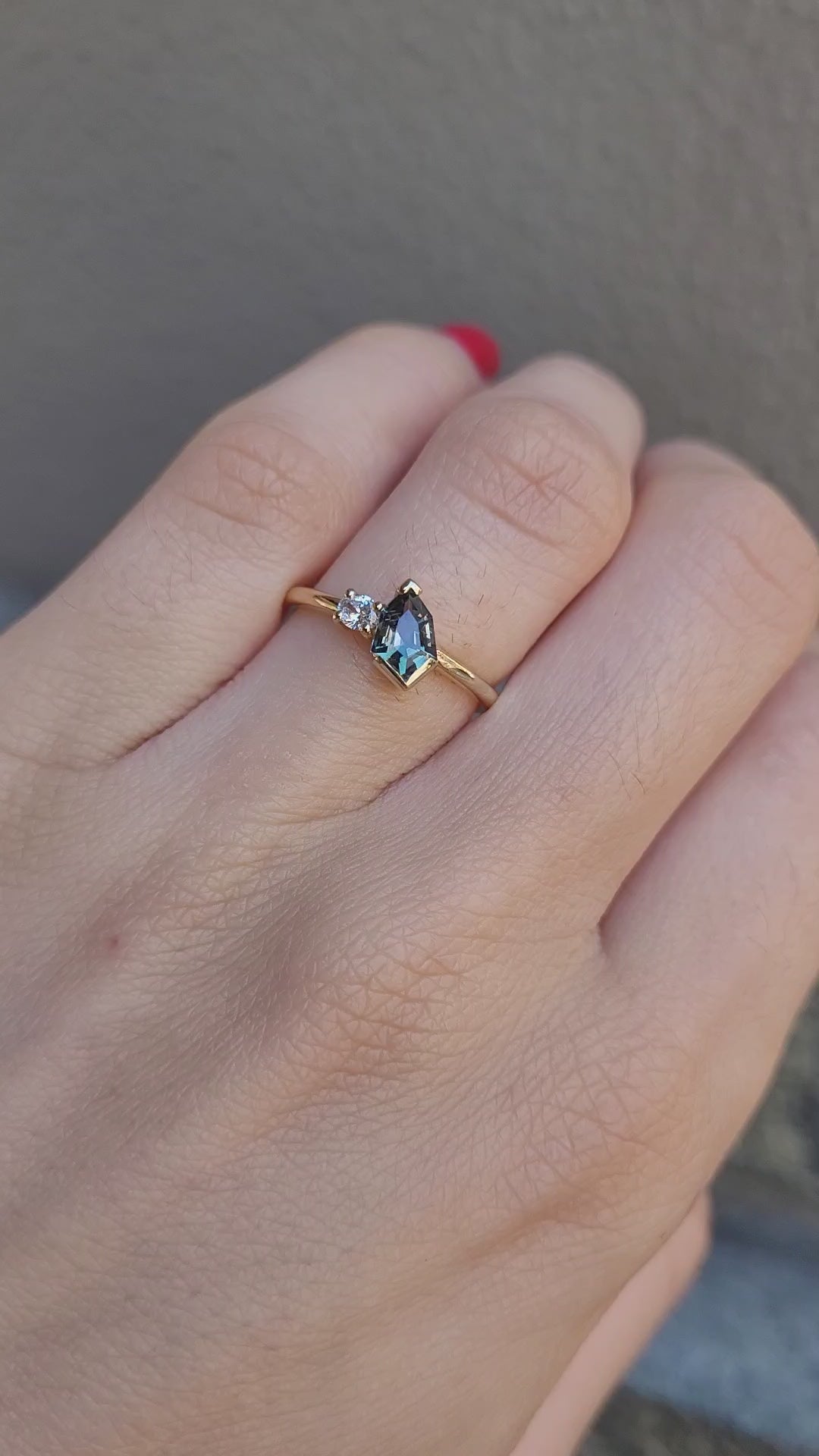video of toi et moi teal sapphire gold ring in gray background