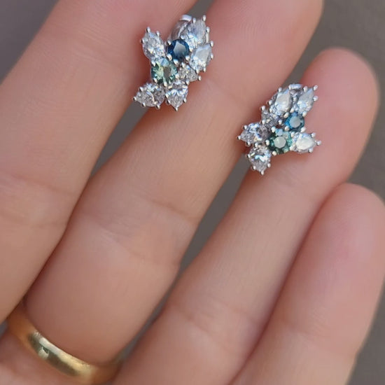 video of Australian Teal Sapphire & Moissanite Cluster Earrings held between fingers