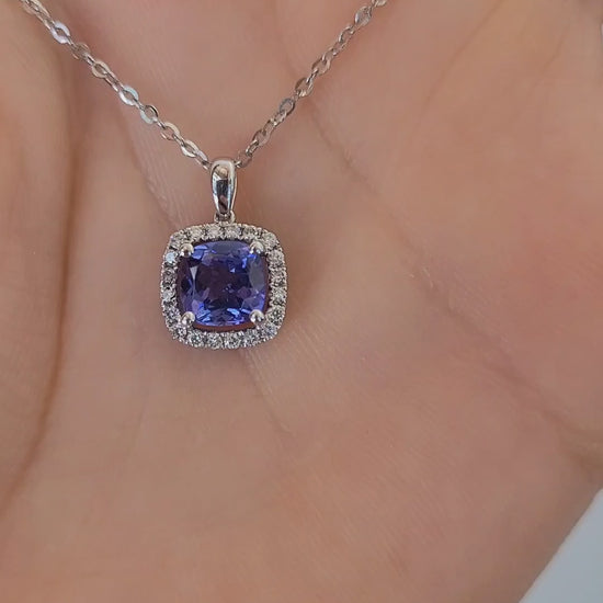 video on hand of Natural tanzanite diamond pendant in white gold in gray background