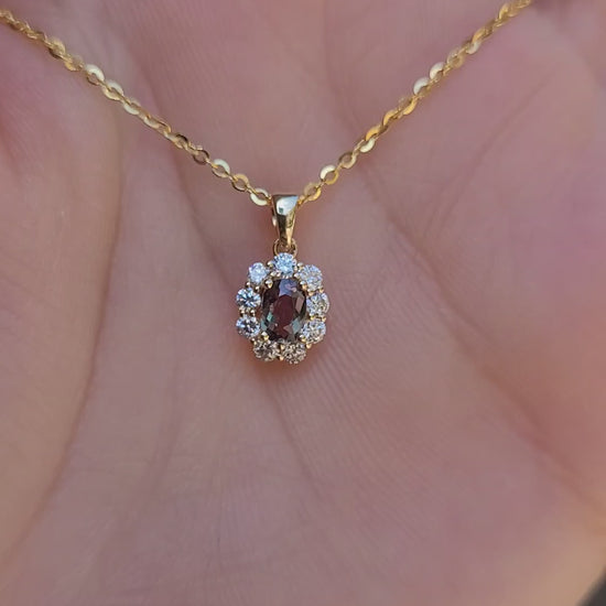 video of Natural Alexandrite Halo Pendant 0.34ct Oval Cut in 18K Yellow Gold in neutral background held in a hand