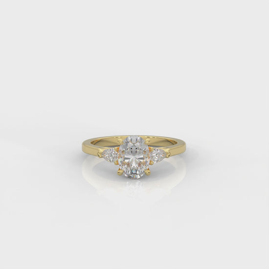 video of gold ring with two pear-shaped diamonds on a white background