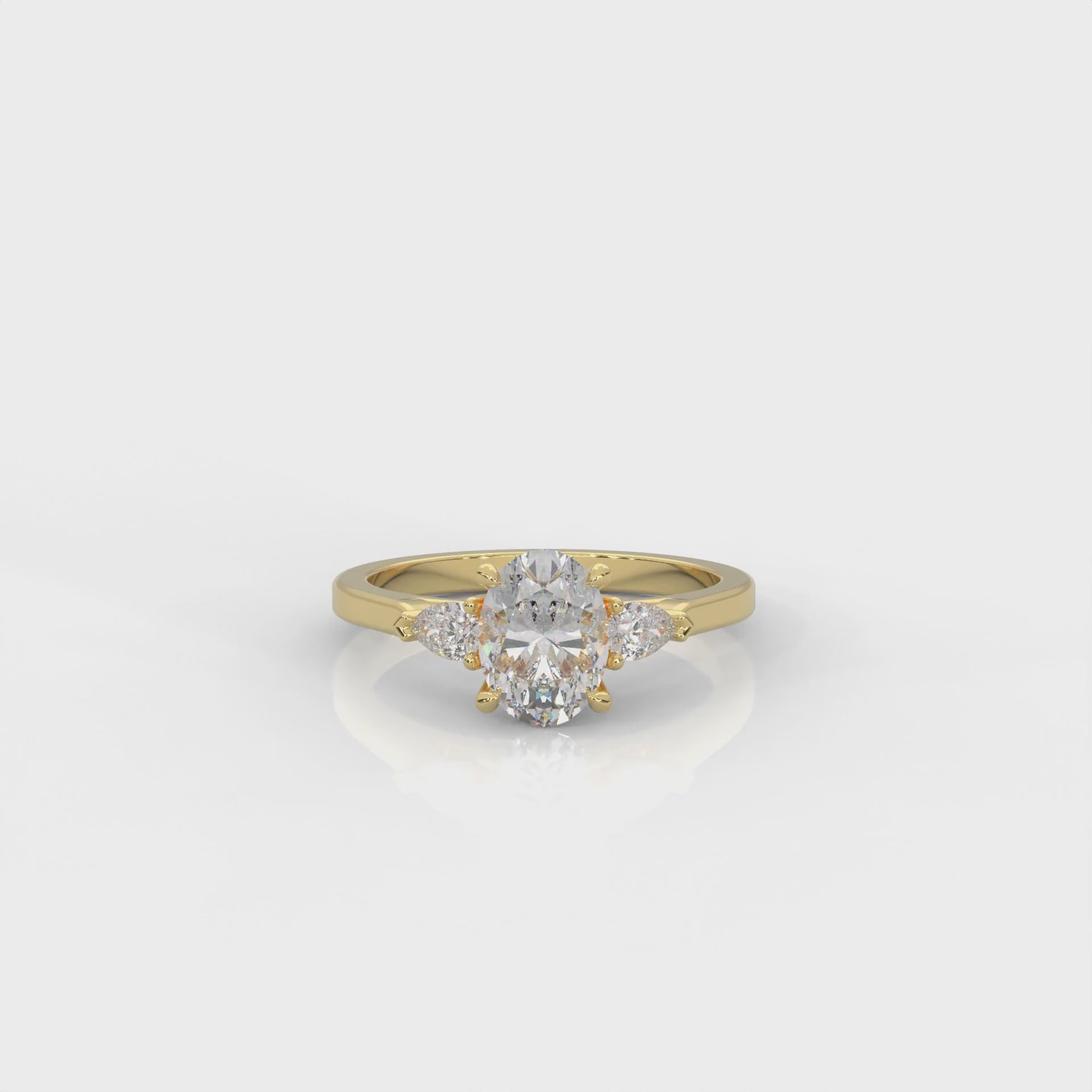 video of gold ring with two pear-shaped diamonds on a white background