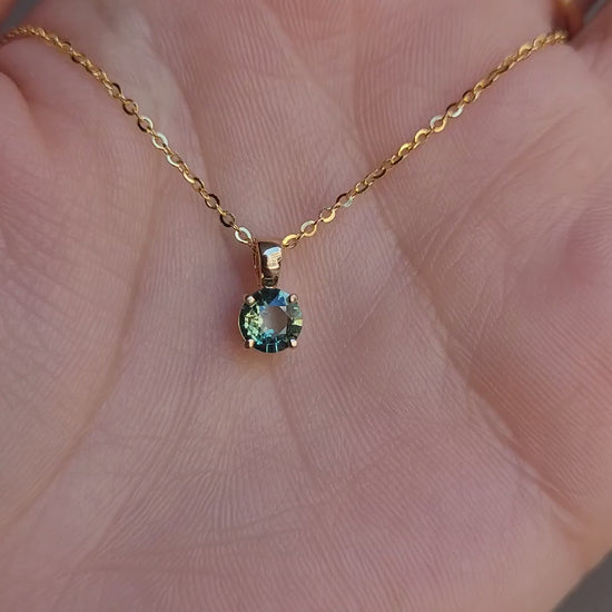 video of Australian teal sapphire pendant in 18K yellow gold