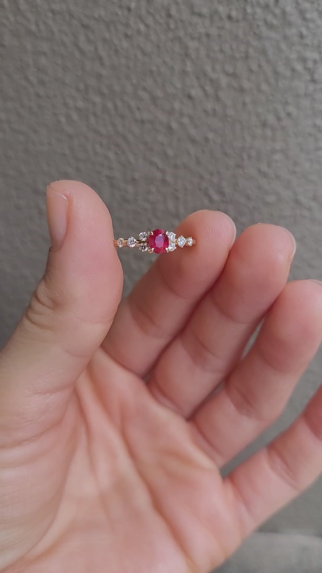 video of ruby and diamonds gold ring in yellow gold in neutral background
