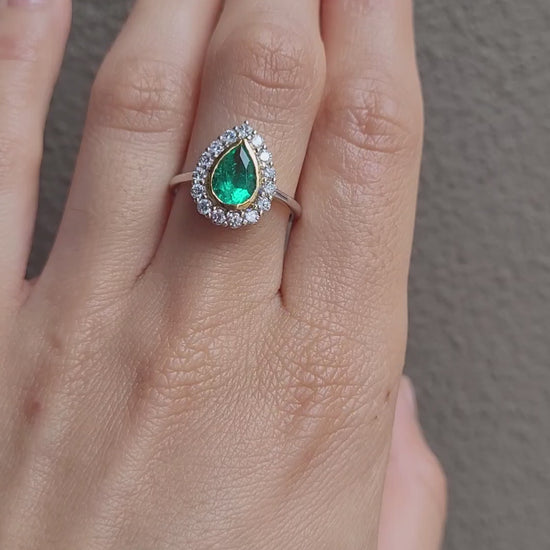 video of Hand wearing a Colombian Pear Emerald Halo Ring 1.17ct in 18K White & Yellow Gold 