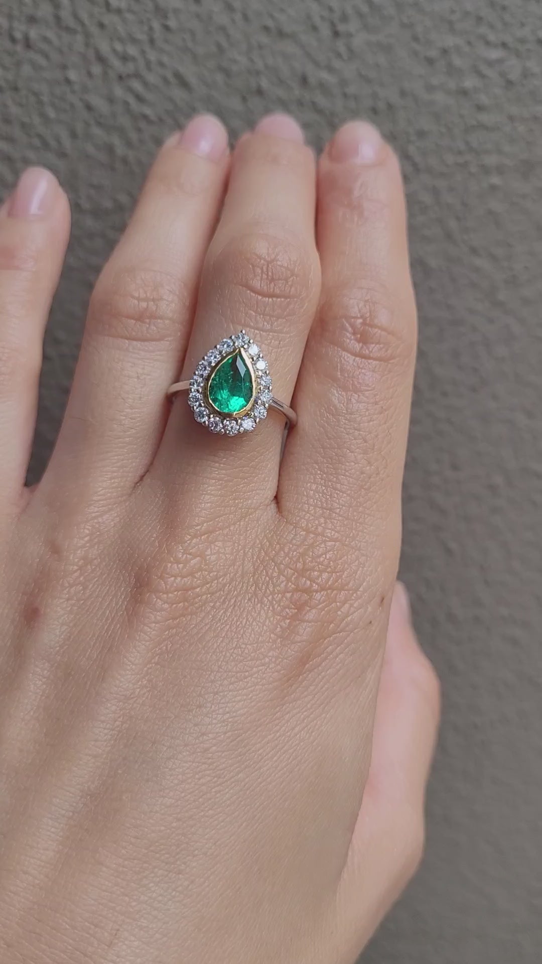 video of Hand wearing a Colombian Pear Emerald Halo Ring 1.17ct in 18K White & Yellow Gold 