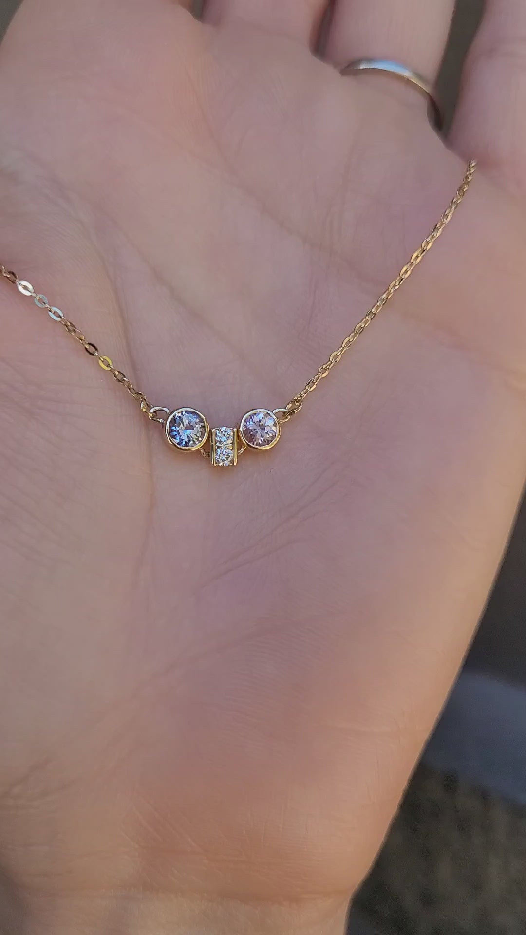 video of Pink Sapphire & Purple Blue Sapphire Diamond Pendant in 18K Yellow Gold held on hand 
