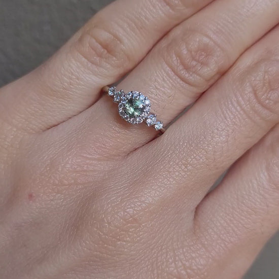 video on hand of Natural Alexandrite and Diamond Halo Ring in 18K Yellow Gold in neutral background