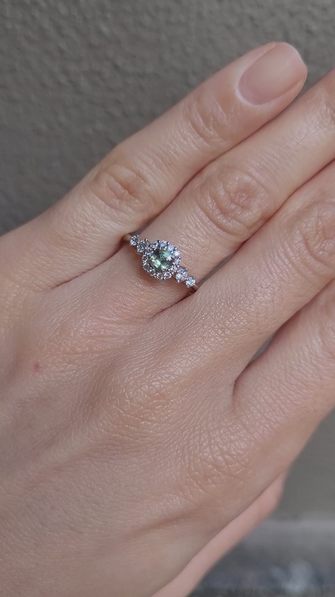 video on hand of Natural Alexandrite and Diamond Halo Ring in 18K Yellow Gold in neutral background