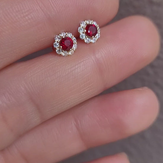 video of ruby studs held on a hand