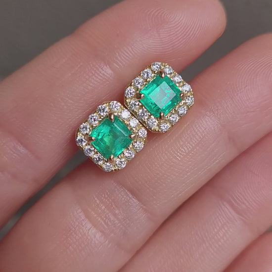 video of hand holding Colombian Emerald 1.91ct & Diamond Halo Stud Earrings