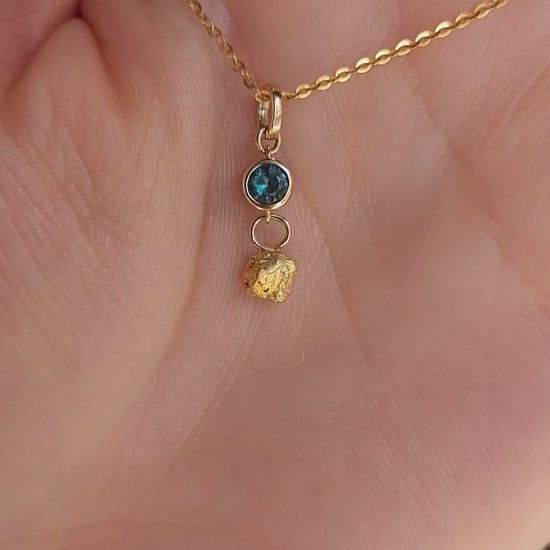 video on hand of sapphire and gold nugget pendant