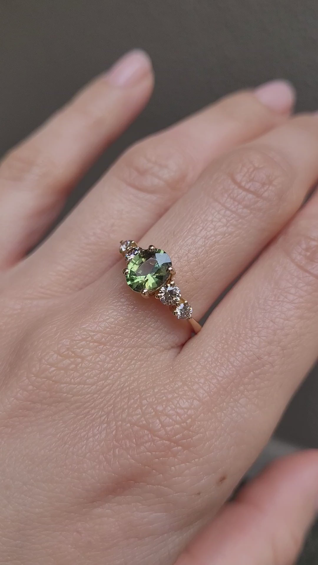 video of hand wearing Green Sapphire & Argyle Champagne Diamond Ring