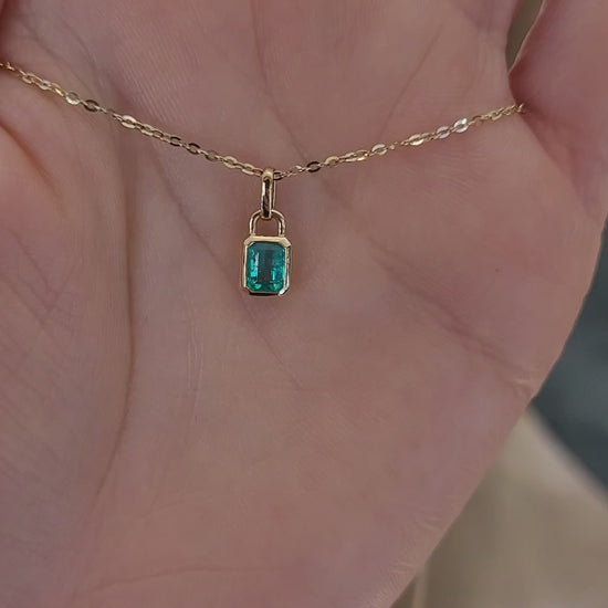 video of 0.41ct Colombian Emerald Pendant on a hand