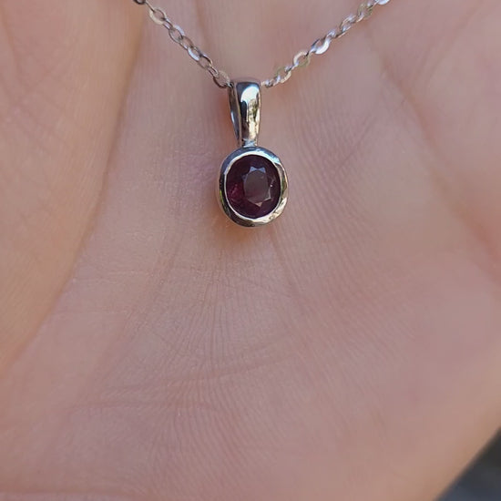 video of Platinum pendant with natural ruby shown on a hand