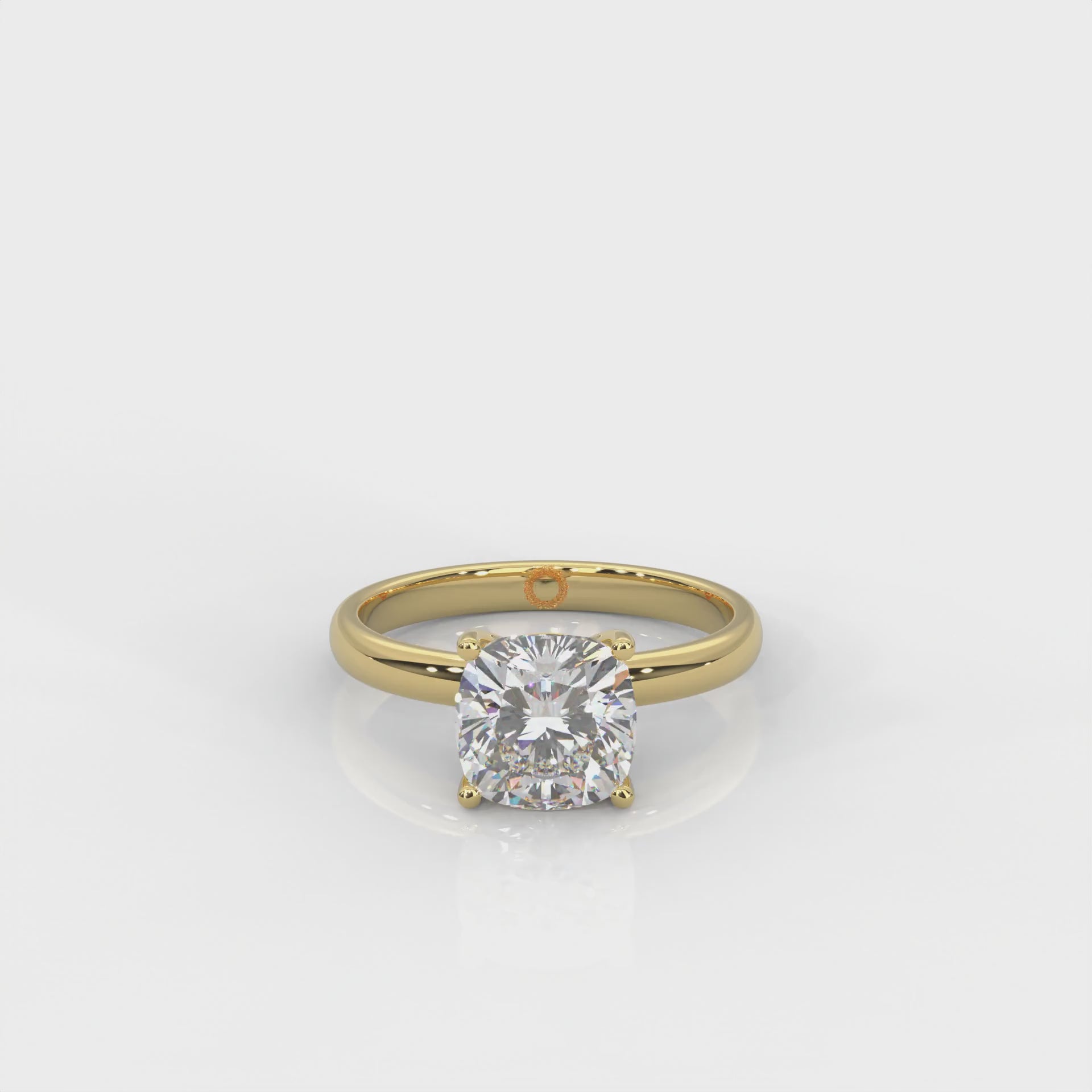 front view of Yellow gold solitaire ring with cushion cut diamond on a white background