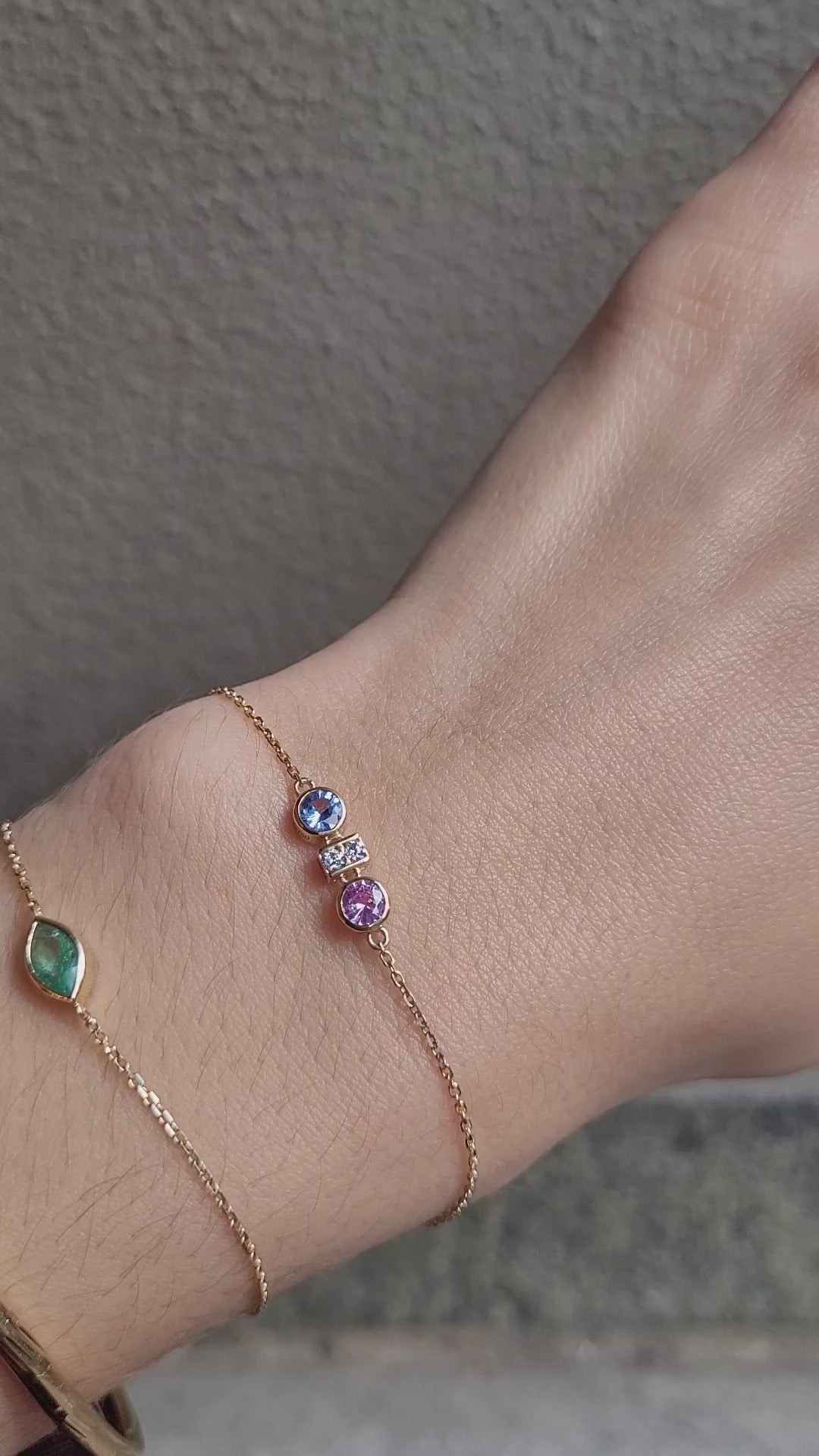 video of Pink and Blue Sapphire Diamond Bracelet in 18K Yellow Gold worn in wrist in neutral background