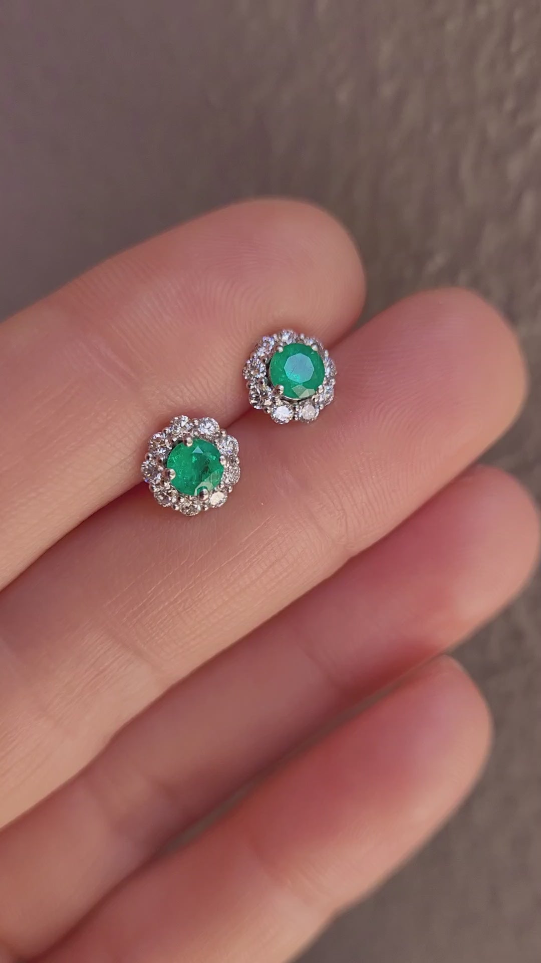 video of Colombian Emerald earrings held in hand