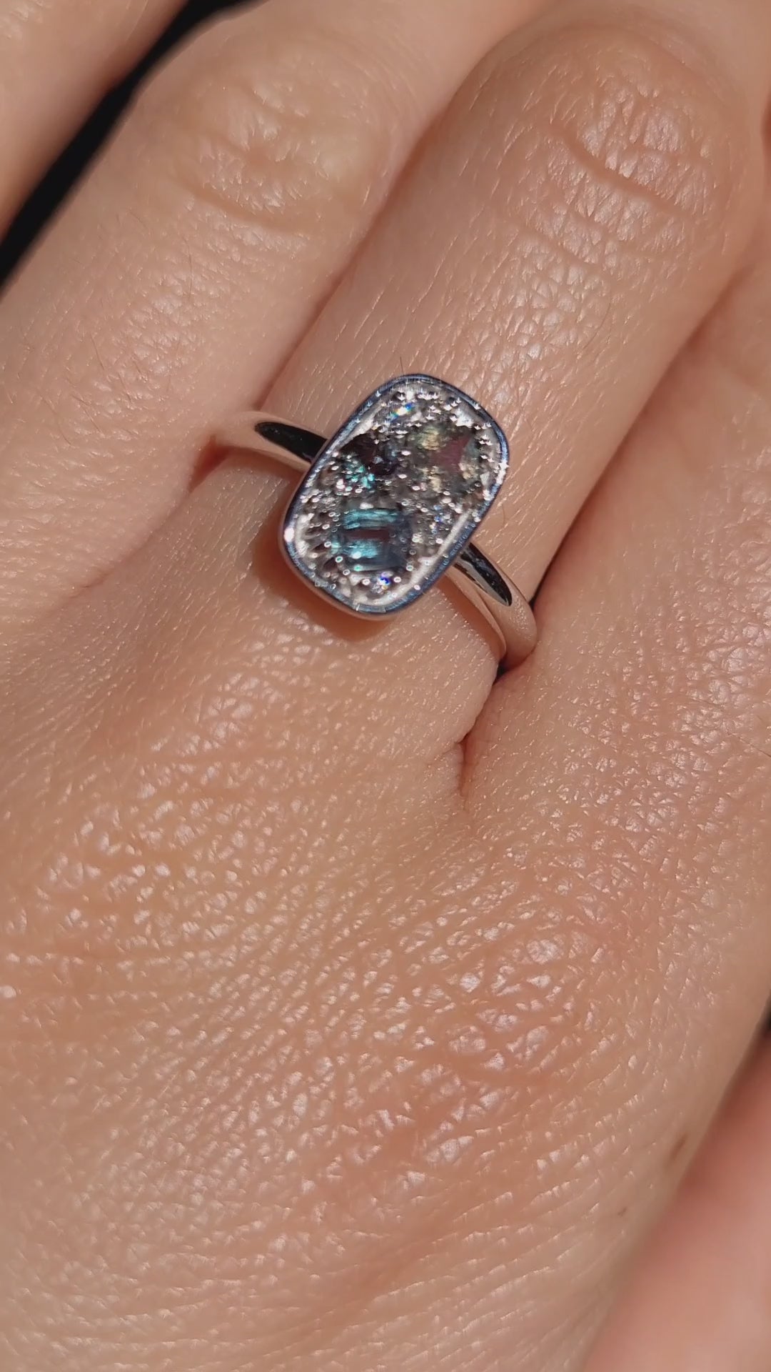 video of a hand wearing a Natural Alexandrite & Diamond Composition Ring in Platinum under natural light