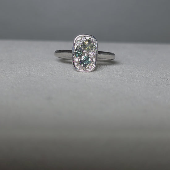 video of alexandrite and diamonds ring in platinum under different lighting conditions
