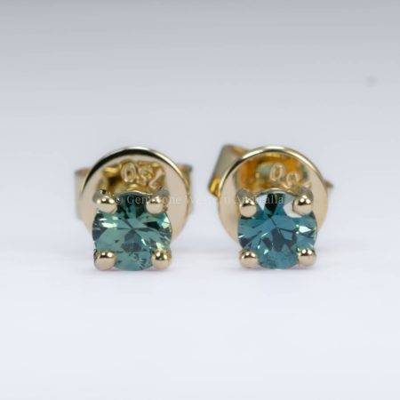 Close-up view of Australian teal sapphires stud earrings in 18K yellow gold