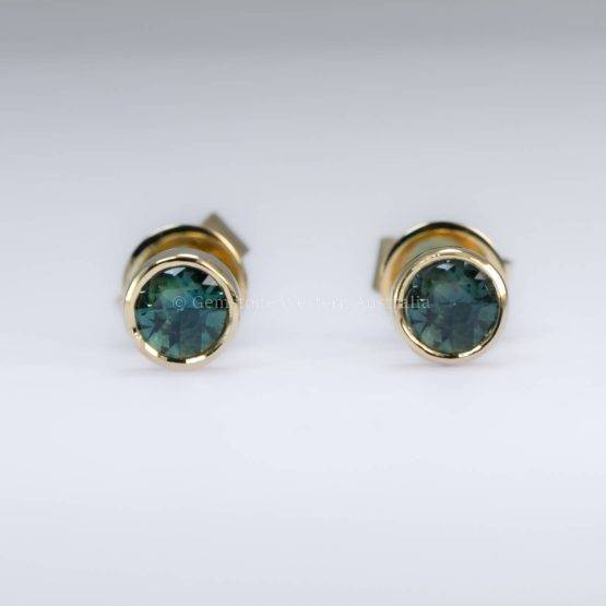 Pair of 3.5mm Australian teal sapphire stud earrings in a bezel setting, crafted in 18K yellow gold.