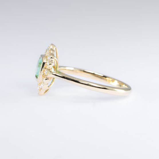 side view of Art Deco Inspired Colombian Emerald Ring with Diamond Halo in 18K Yellow Gold