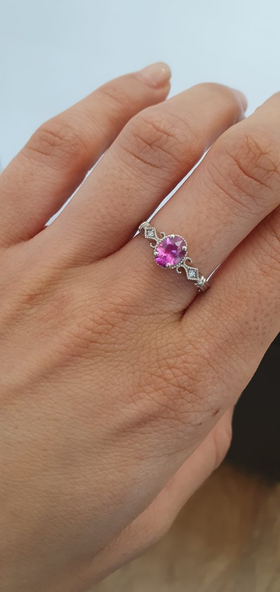 view on hand of Oval Cut Pink Sapphire and Diamond Ring in Platinum 950 with Filigree Detail