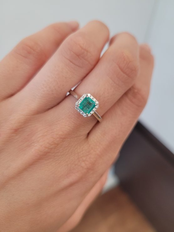 Photo of view on hand of Emerald Cut Colombian Emerald Ring with Diamond Halo in Platinum - 1982790