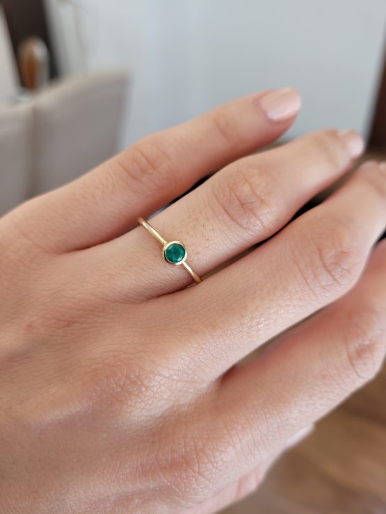 photo on hand of Petite 9K Yellow Gold Ring with 3.6mm Round Cut Natural Colombian Emerald