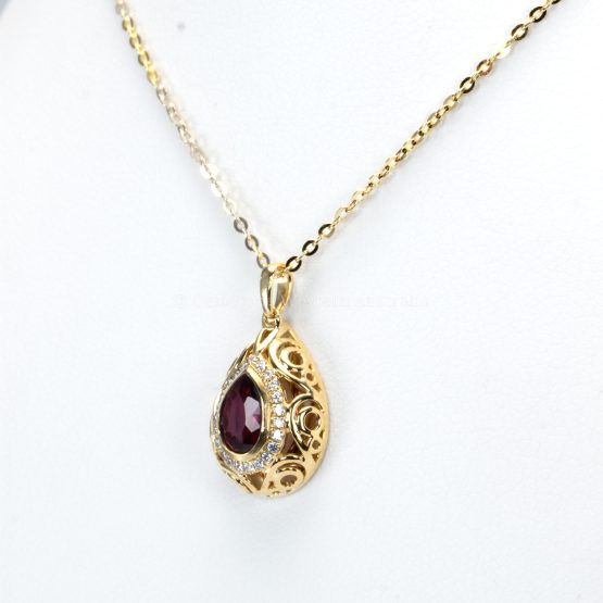 side view of Pear Shape Unheated Ruby Pendant with Diamond Halo in Elegant Drop Design