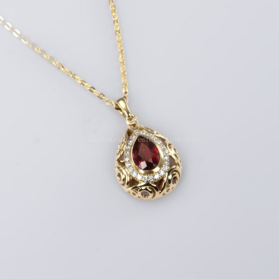 bird's eye view of Pear Shape Unheated Ruby Pendant with Diamond Halo in Elegant Drop Design