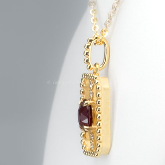 side view of 0.54ct Natural Ruby Pendant in 18K Yellow Gold with Diamond Accents