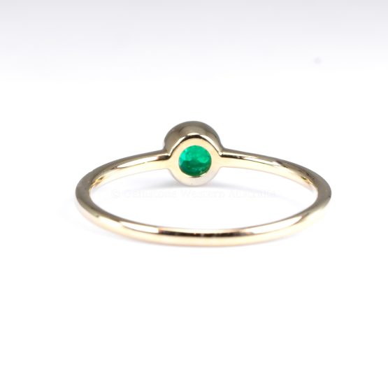 back view of hand of Petite 9K Yellow Gold Ring with 3.6mm Round Cut Natural Colombian Emerald