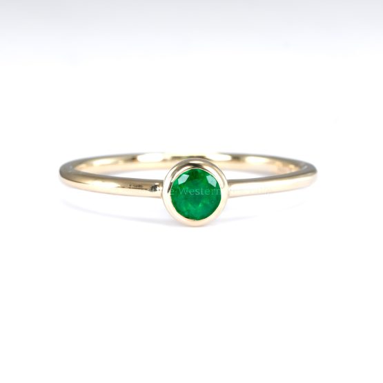 front view of hand of Petite 9K Yellow Gold Ring with 3.6mm Round Cut Natural Colombian Emerald