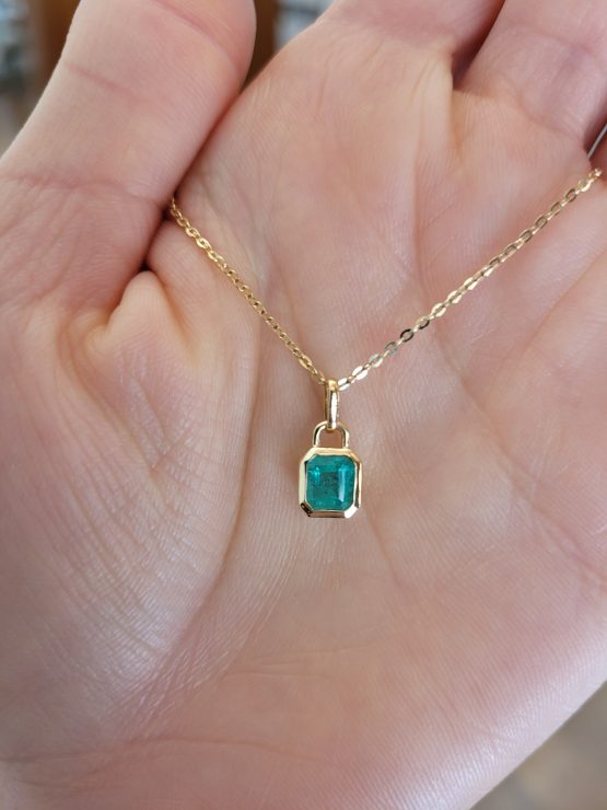 view on hand of 0.41ct Colombian Emerald Pendant in Emerald Cut | 18K Yellow Gold