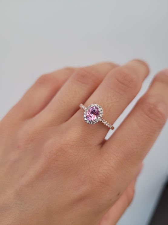 photo on hand 1.08ct Oval Pink Sapphire Halo Ring in Platinum and 18K Rose Gold