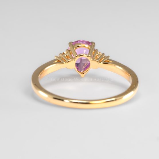 back view of Unheated Pear Cut Pink Sapphire Ring with Diamond Cluster in 18K Yellow Gold