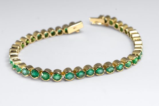 bird's eye view of 6.82ct Colombian Emerald Tennis Bracelet in 18K Yellow Gold – Certified