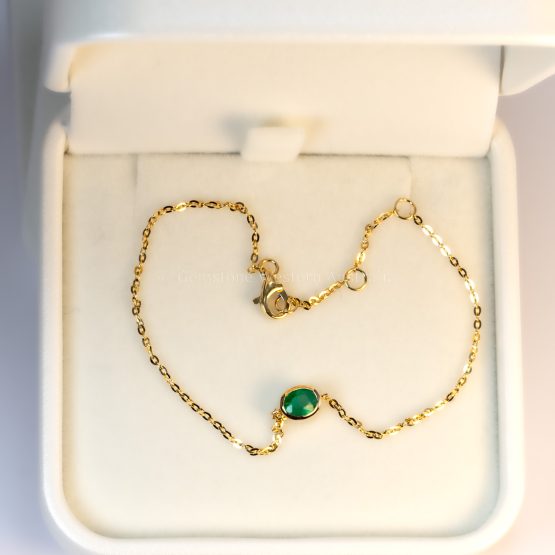 bird's eye view on box of 18K Yellow Gold Colombian Emerald Bracelet