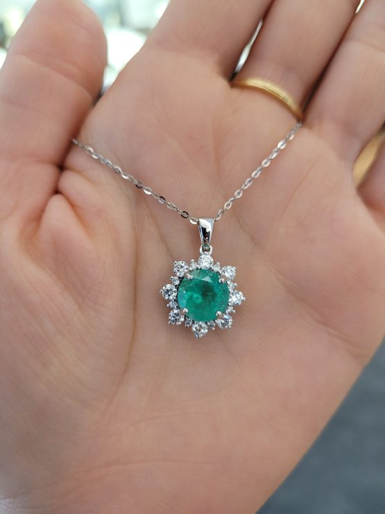 photo on hand of Round Colombian Emerald Pendant with Diamond Halo in Platinum 950