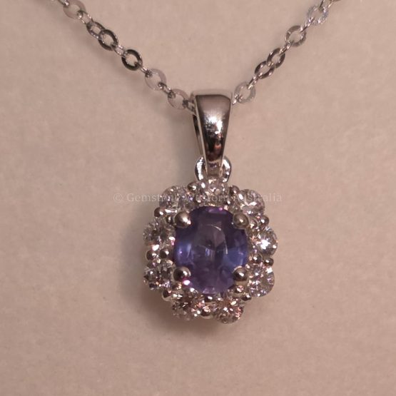 photo in incandescent light of Oval Alexandrite Pendant with Diamond Halo in Platinum