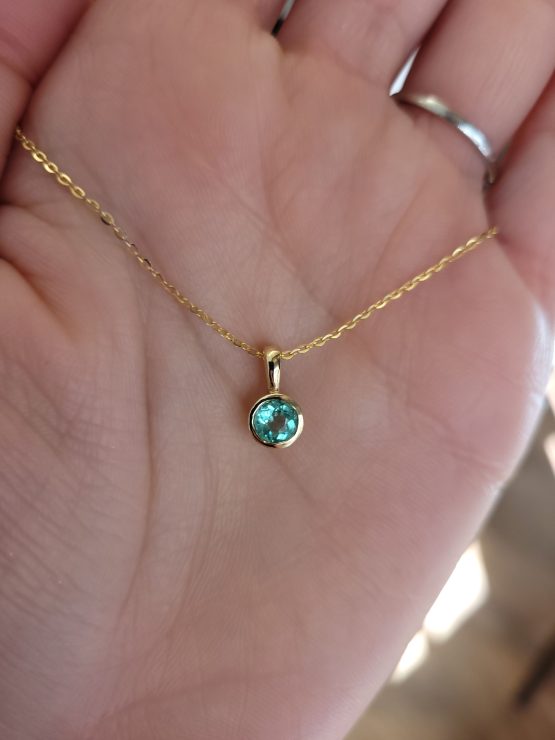 view on hand of bezel set emerald pendant - 1982863