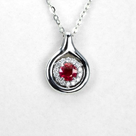 view on hand of Round Ruby and Diamond Halo Pendant in White Gold - 1982855