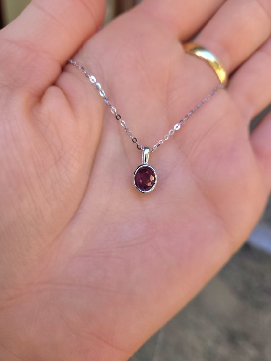 view on hand of Ruby Platinum Pendant with Oval Cut Unheated Ruby in Bezel Setting - 1982877