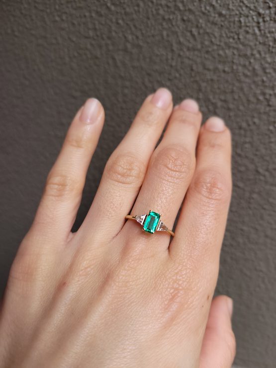 view on hand of Elongated Emerald Cut Ring with Colombian Emerald and Trapezoid Diamonds in 18K Yellow Gold - 1982884